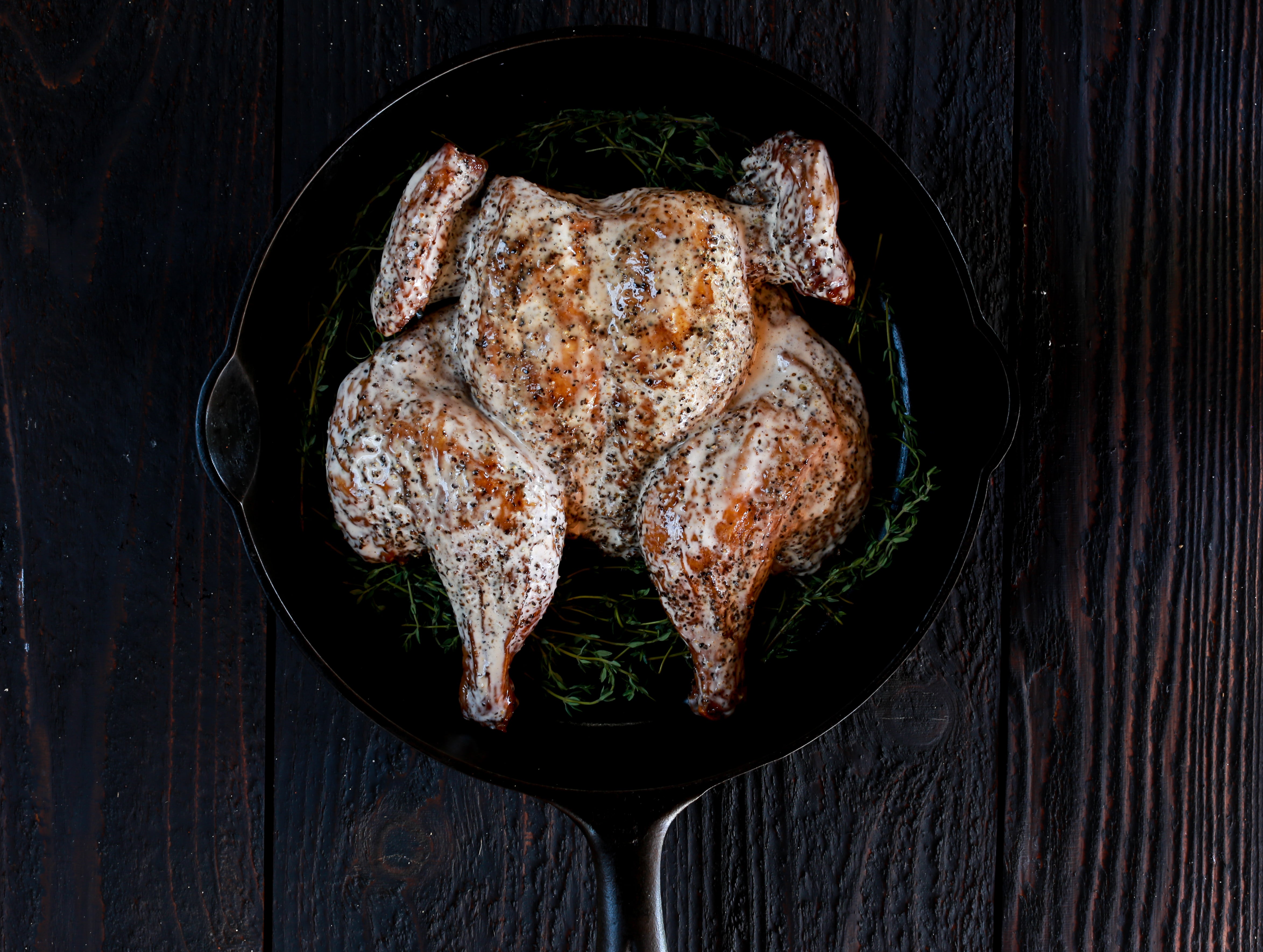 Whole BBQ chicken with white sauce.